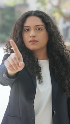 Vertical Video of Curly Hair Indian Businesswoman Saying No With Finger at Camera