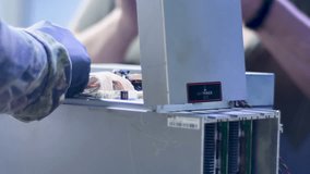 Close-up view of the complex internal structure and ribbon cables of a high-power ASIC miner being repaired. - Powered by Shutterstock - Get 15% off with code: PIKWIZARD15