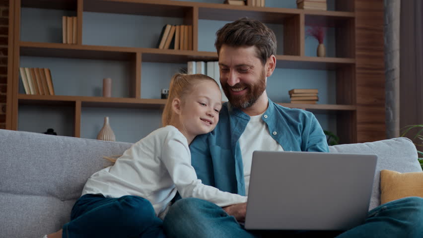 Happy Caucasian family at home father dad and little child kid girl using laptop watching funny video online choosing goods shopping in internet together enjoy weekend daddy with daughter browsing pc - Powered by Shutterstock - Get 15% off with code: PIKWIZARD15