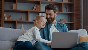 Happy Caucasian family at home father dad and little child kid girl using laptop watching funny video online choosing goods shopping in internet together enjoy weekend daddy with daughter browsing pc - Powered by Shutterstock - Get 15% off with code: PIKWIZARD15