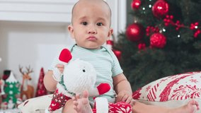 Asian christmas baby sitting floor with plush snowman and decorated tree creating joyful holiday moment adorable baby boy christmas tree ornament red green toy cozy living room sitting with festive - Powered by Shutterstock - Get 15% off with code: PIKWIZARD15