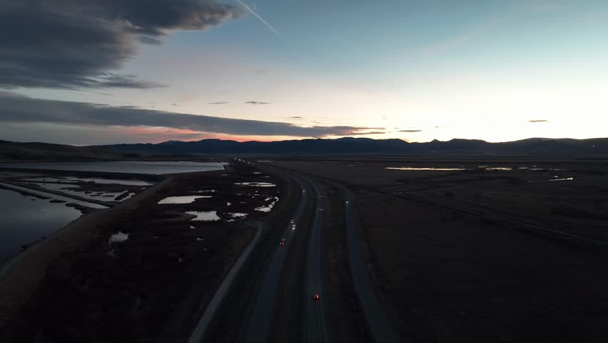 Aerial drone view of highway, lakes, and river in Montana USA at sunset