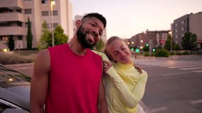Young multiracial couple in sportswear laughing and relaxing together after a fitness workout. Cheerful athletes embracing outdoors in a city street while having fun together - Powered by Shutterstock - Get 15% off with code: PIKWIZARD15