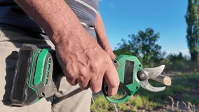 Video of lithium battery-powered pruning shears cutting branches. - Powered by Shutterstock - Get 15% off with code: PIKWIZARD15