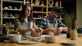 Caucasian woman man teacher student potter artist teaching sculpture ceramics clay process modeling at pottery workshop couple date girl guy creating crockery handmade eco craft studying in art studio - Powered by Shutterstock - Get 15% off with code: PIKWIZARD15