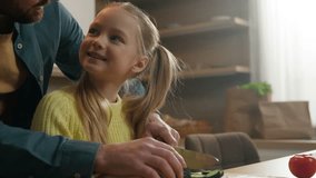 Happy family cooking at kitchen smiling father with daughter talking carefree cook vegan dinner vegetarian food Caucasian dad teach kid girl child cutting cucumber helping using knife prepare salad - Powered by Shutterstock - Get 15% off with code: PIKWIZARD15