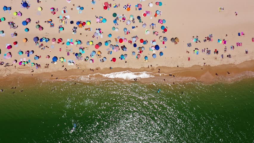 Sunny beach scene, Colorful umbrellas fill shoreline, Bustling seaside with lively sunbathers and umbrellas, Vivid coastal landscape showing crowded beach with umbrellas and waves