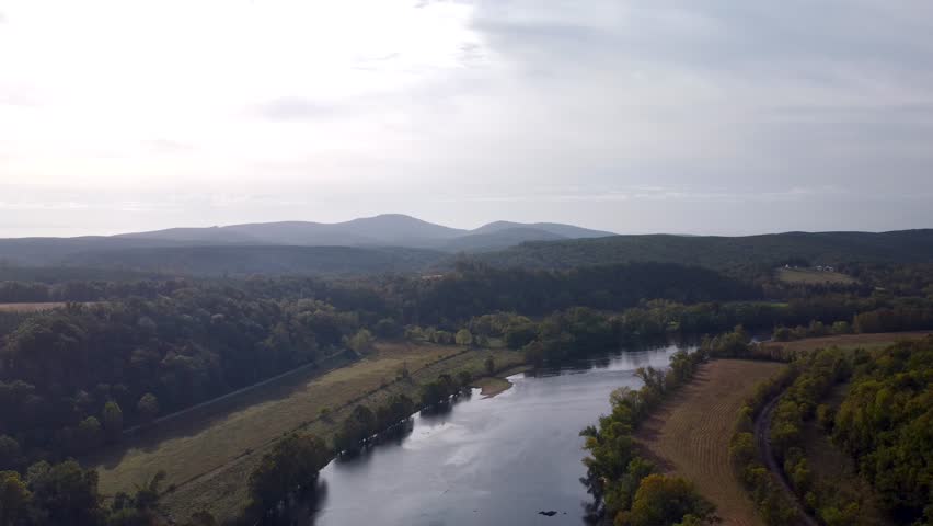 Aerial video of the Upper James River flowing between forested shores near James River State Park.