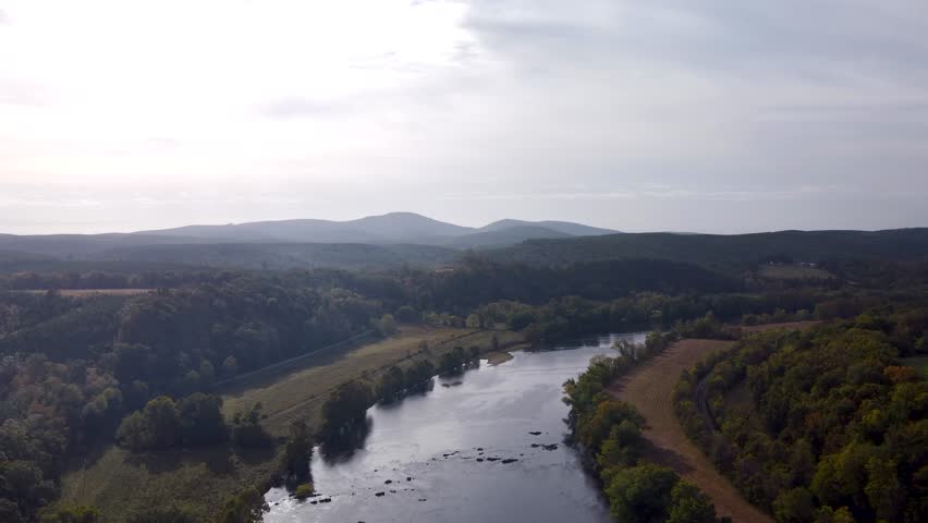 Aerial video of the Upper James River flowing between forested shores near James River State Park.