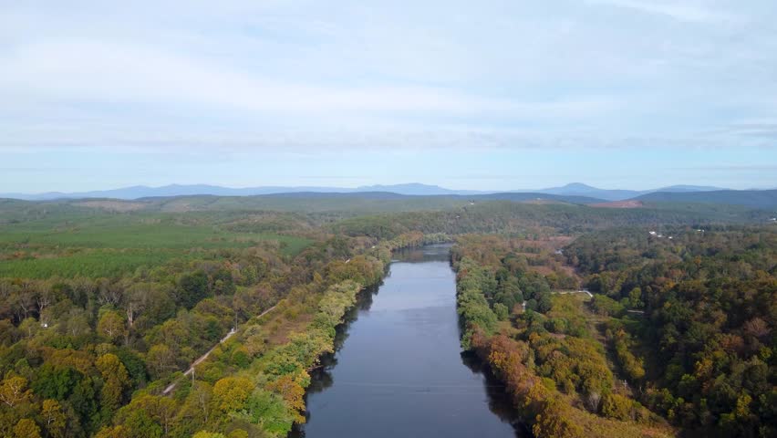 Aerial video of the Upper James River flowing between forested shores near James River State Park.