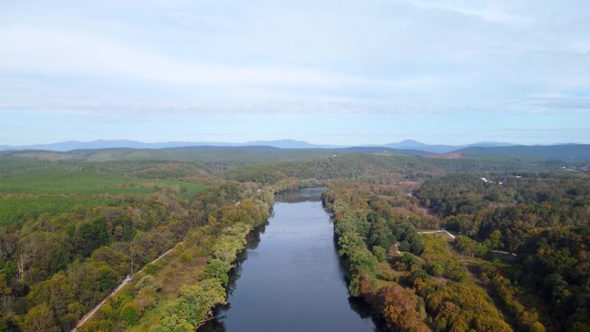 Aerial video of the Upper James River flowing between forested shores near James River State Park.