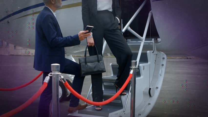 Senior man holding smartphone, showing boarding info to exec on jet stairs, graphics moving around. Bizjet, colleagues, tarmac, airside, aircraft, overcast, luxury