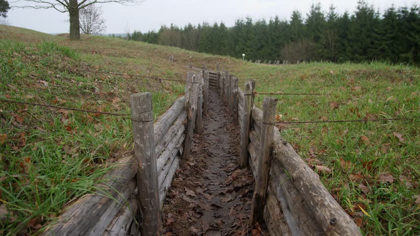 A first-person view of movement through a military trench at a fortification in Ukraine or Russia slow motion 4k