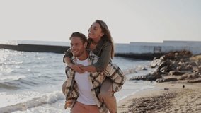 Young fun couple two friends family man woman wear shirt casual clothes together giving piggyback ride to joyful sit on back rest relax in free time walk on sea sand shore beach seaside in summer day - Powered by Shutterstock - Get 15% off with code: PIKWIZARD15