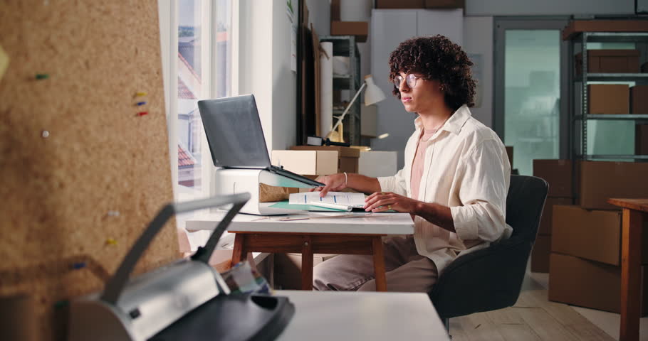 Man, laptop and reading document in startup for stock update, supply chain and shipping bills. Person, pc and paperwork with inventory checklist, quality assurance and order invoice for delivery cost