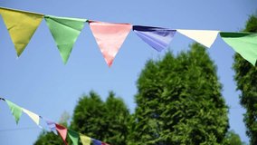 Outdoor Party Decorations: Vivid Multicolored Flags Under a Sunny Sky, Representing Fun, Festivity, and the Simple Joys of a Beautiful Day - Powered by Shutterstock - Get 15% off with code: PIKWIZARD15
