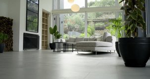 Camera starting low in living room, tilting upward showing sectional sofa, tables, pendants, garden. Interior, contemporary, minimalist, tranquility, elegance, decor, architecture - Powered by Shutterstock - Get 15% off with code: PIKWIZARD15