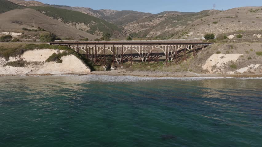 Gaviota, CA - Gaviota Bridge California Aerial View on a Sunny Day With Train Tracks, Graffiti Art and Rest Area in Santa Barbara County, Next to the US Route 101 Freeway, Next to the Pacific Ocean