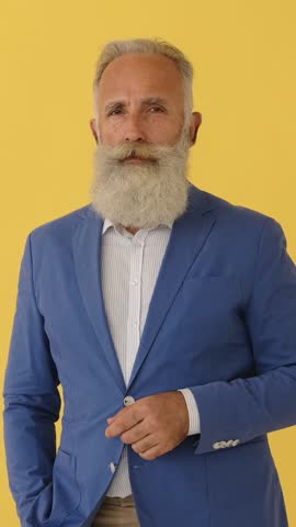 Stylish senior man with beard reacts with shock and disbelief