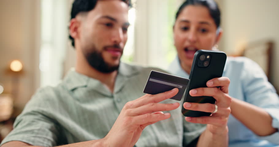 Credit card, happy or couple in home with phone, shared cart or sales promo in eft transaction. Digital, easy shopping or people in house with tech, remote service or discount on gift purchase.