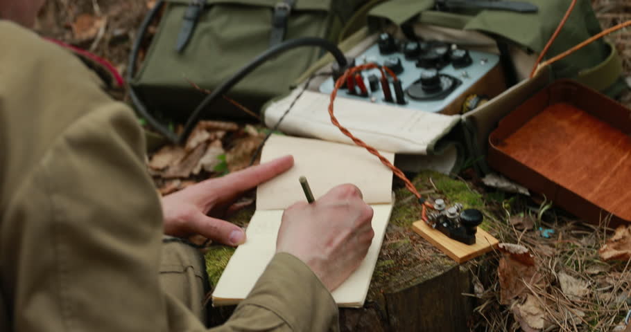 Russian Soviet Infantry Red Army Soldier In World War II using Russian Soviet Portable Radio Transceiver In Trench Entrenchment In Spring Autumn Forest. 4K. Headphones And Telegraph Key. Close Up