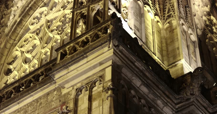 Prague St. Vitus Cathedral gothic church building detailed view at night illuminated in the dark, tall towers exterior with decorated details