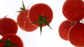 Close-up fresh red cherry tomatoes moving and splashing in water in slow motion - Powered by Shutterstock - Get 15% off with code: PIKWIZARD15