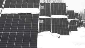 Snow covered solar panel array with winter weather conditions outside view. - Powered by Shutterstock - Get 15% off with code: PIKWIZARD15