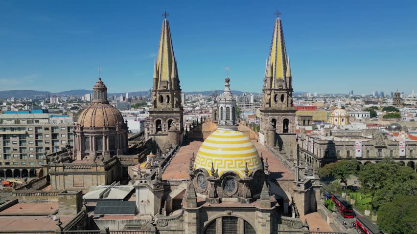 Aerial retreating shot from cathedral in Guadalajara showing wide view of Plaza Tapatia and surroundings