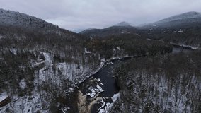 Cinematic winter flyover above triangular intersections of snowy river branches forming geometric natural shapes between mountains. - Powered by Shutterstock - Get 15% off with code: PIKWIZARD15