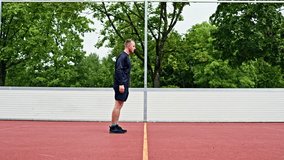 Athletic young man doing sports outdoors on a sports ground. Man doing sports and leading a healthy lifestyle. Man on a morning spotting session in the park. - Powered by Shutterstock - Get 15% off with code: PIKWIZARD15
