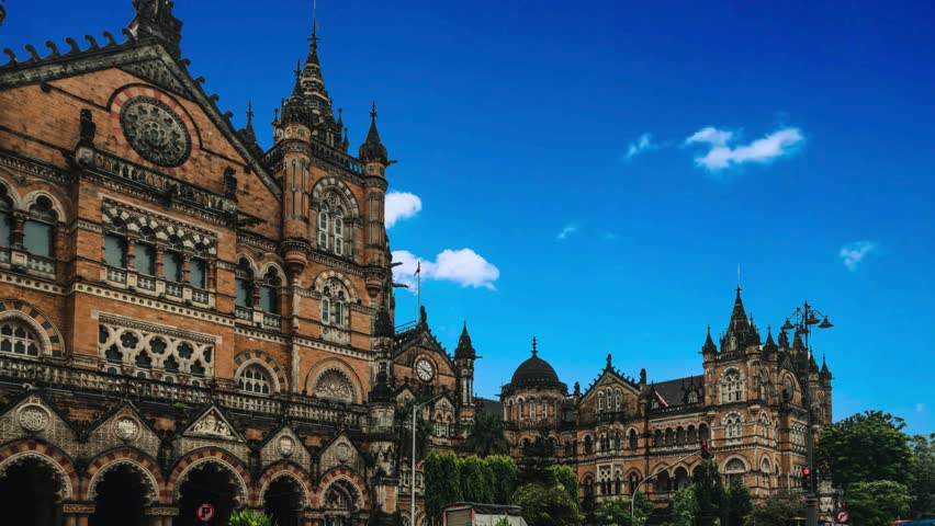 MUMBAI, INDIA - December 18, 2021 : BEST buses, Local taxis and traffice across streets of CST station,UNESCO World Heritage Site in Mumbaiart, historic, ancient, exterior, victorian, pathway, hard wo