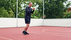 Athletic young man doing sports outdoors on a sports ground. Man doing sports and leading a healthy lifestyle. Man on a morning spotting session in the park. - Powered by Shutterstock - Get 15% off with code: PIKWIZARD15