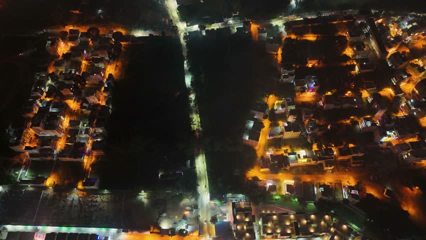 4K Aerial Night View of Bustling Metropolitan City – Urban Lights, Busy Roads, High-Rise Buildings, Nightlife Atmosphere, and Vibrant Tier-1 Suburban Development