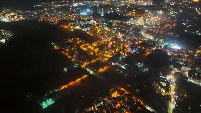 4K Aerial Night View of Bustling Metropolitan City – Urban Lights, Busy Roads, High-Rise Buildings, Nightlife Atmosphere, and Vibrant Tier-1 Suburban Development