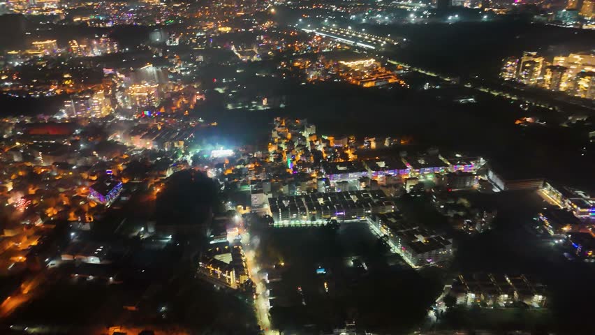 4K Aerial Night View of Bustling Metropolitan City – Urban Lights, Busy Roads, High-Rise Buildings, Nightlife Atmosphere, and Vibrant Tier-1 Suburban Development