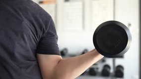 determined male athlete performs dumbbell shoulder presses in modern gym. strength training. fitness, health, dedication to exercise. sporty sport Man Lifting Weights club. Sportsman workout Muscular - Powered by Shutterstock - Get 15% off with code: PIKWIZARD15