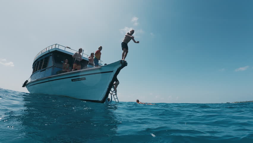 Person jumps into the sea from a boat