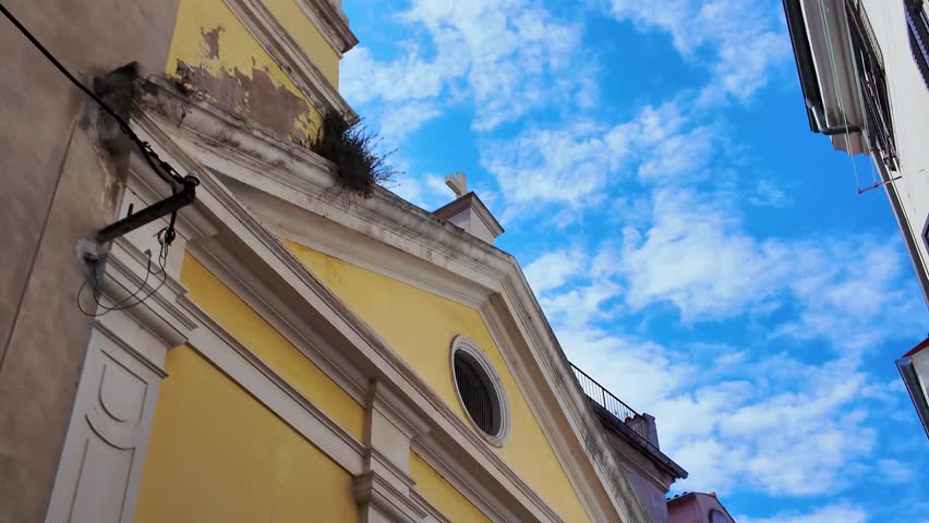 Picturesque street with cobbled floor and colorful old houses in the coastal town of Piran, Slovenia.