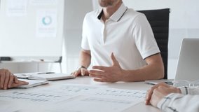 Professional team reviewing financial charts, collaborating intently around conference table in contemporary workspace, sharing insights during strategic planning session - Powered by Shutterstock - Get 15% off with code: PIKWIZARD15