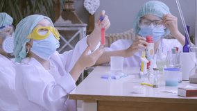 Young students in protective gear engaging in hands-on chemistry experiment, curiosity and learning practical laboratory work, Science education, scientific discovery and mixing chemical solutions - Powered by Shutterstock - Get 15% off with code: PIKWIZARD15