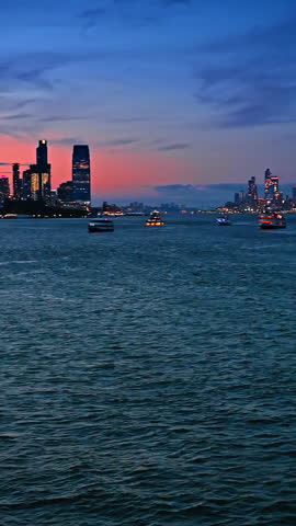 Dusk time travel on board of the boat or riverboat. Beautiful skyline of New York at backdrop. Vertical video.