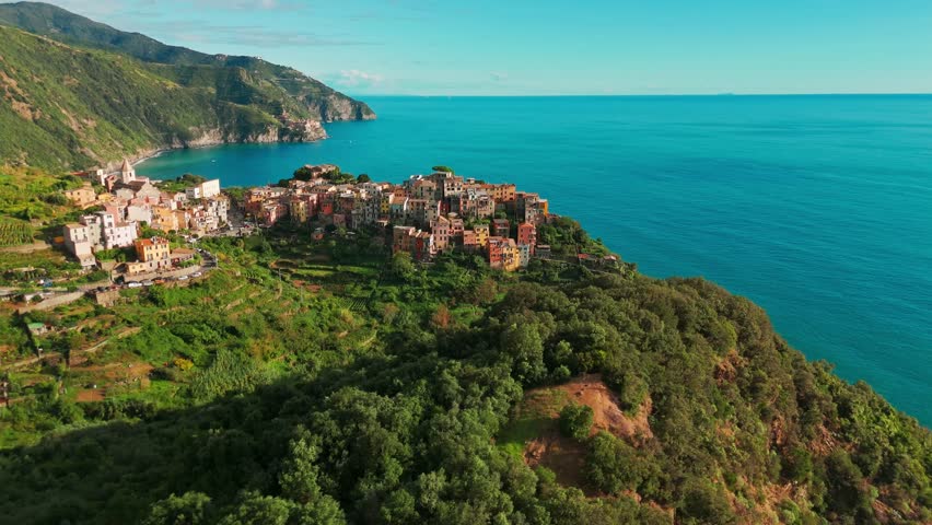 Aerial view of the Corniglia town in the famous Cinque Terre, Italian Riviera, Liguria, Italy. Stunning historic village with colorful buildings nestled between cliffs and the Ligurian Sea. 
