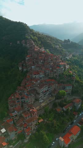 Aerial view of the picturesque town of Apricale at sunset in, province of Imperia, Liguria, Northern Italy. Charming medieval village is nestled in the mountains and surrounded by scenic landscapes.