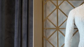 Close-up of an elegant white wedding dress with intricate floral embroidery on a mannequin. This classic and luxurious scene is ideal for bridal fashion, haute couture, or wedding themes. - Powered by Shutterstock - Get 15% off with code: PIKWIZARD15