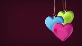 Spinning differently colored heart-shaped Christmas ornaments on a dark background - Powered by Shutterstock - Get 15% off with code: PIKWIZARD15
