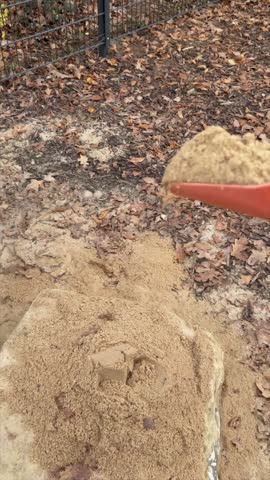 Slow Motion Pouring Sand from Scoop on Playground