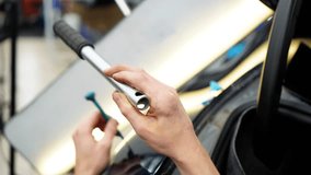  A specialist repairs a dent on the car body without painting. PDR. Process of paintless dent repair on car body. The mechanic at the auto shop with tools to repair dents in car body. Body car repair. - Powered by Shutterstock - Get 15% off with code: PIKWIZARD15