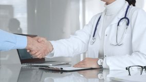 Doctor and patient handshaking, establishing trust and agreement during medical consultation in hospital setting. Medicine, healthcare and science concept - Powered by Shutterstock - Get 15% off with code: PIKWIZARD15