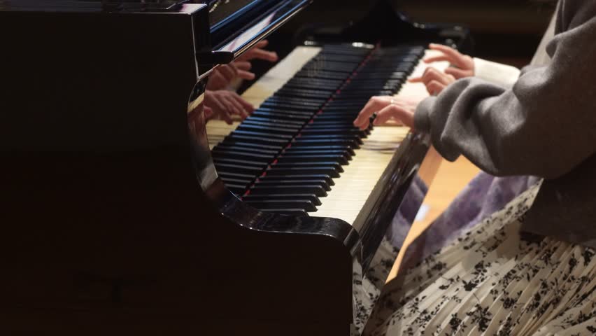 Image of a woman playing the piano